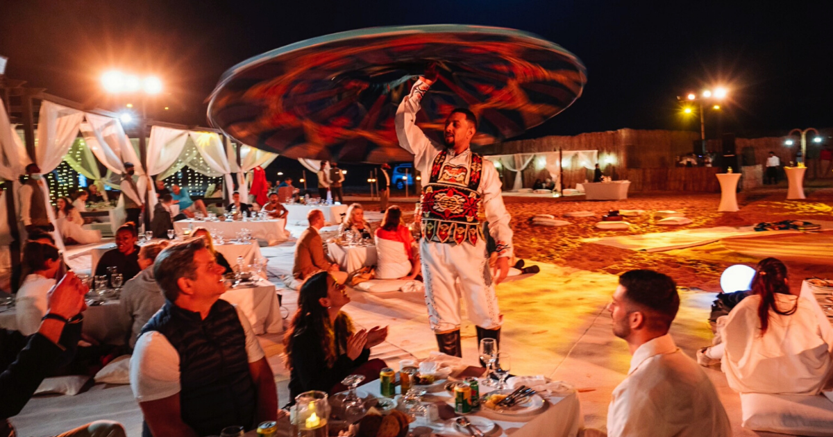 Travel Incentives experience idea; Arabian man performing traditional dance in Dubai desert